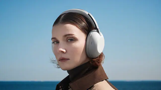 A woman wears the Sony 1000X the Collexion headphones
