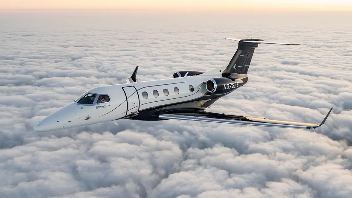 Embraer Phenom 300EV in flight